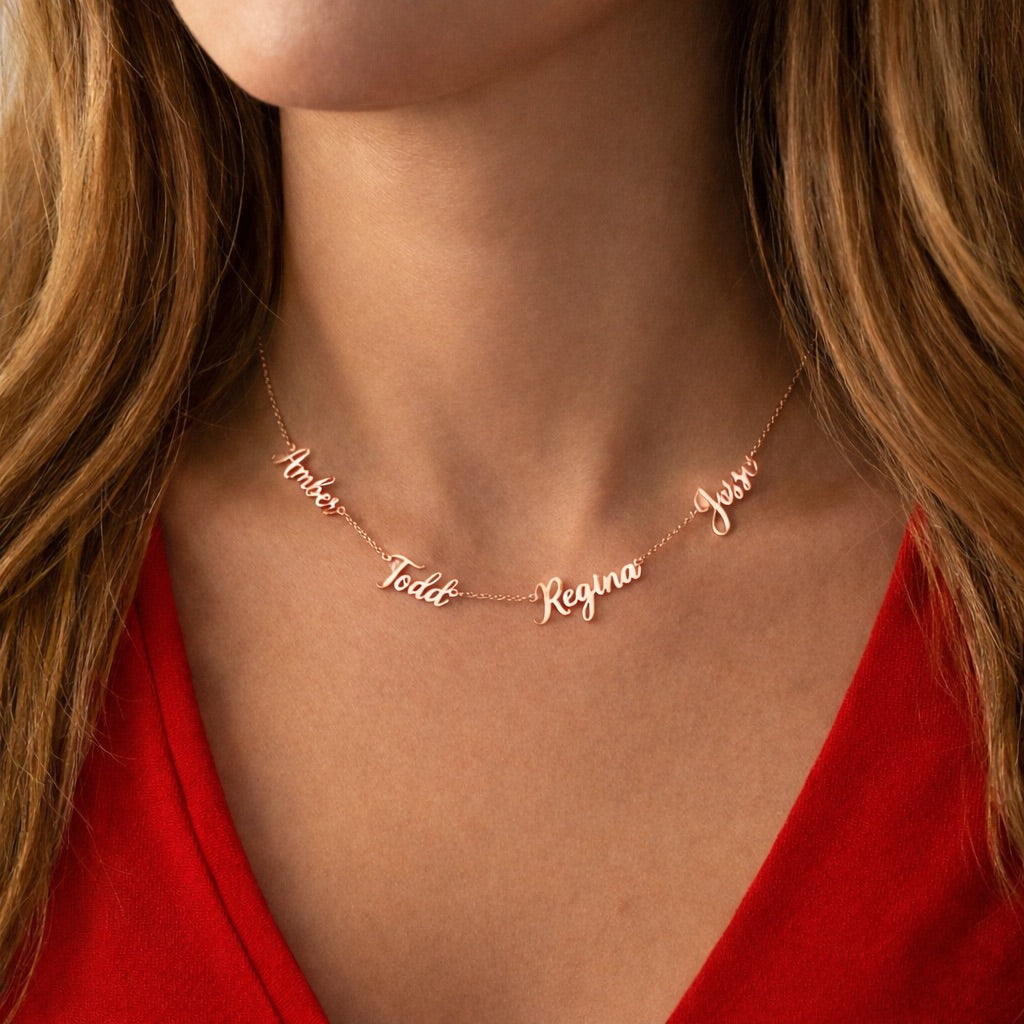 Rose gold name necklace on a person wearing a red top